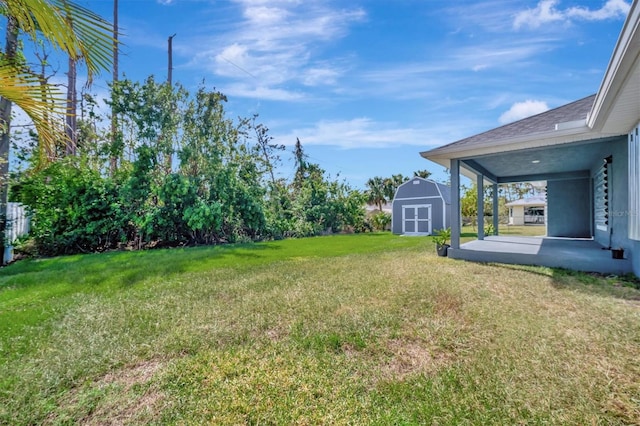 view of yard featuring a shed and a patio area