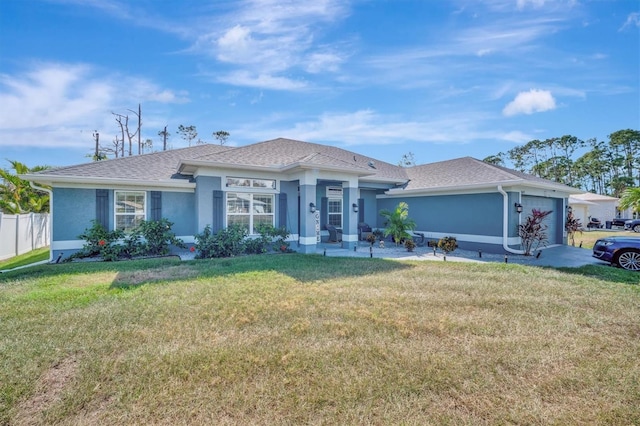 single story home featuring a garage and a front yard