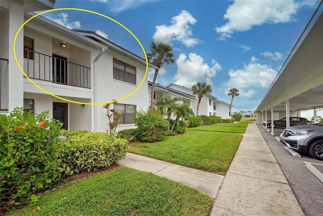 view of community with a carport and a yard