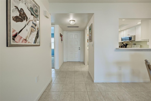 corridor featuring light tile patterned flooring