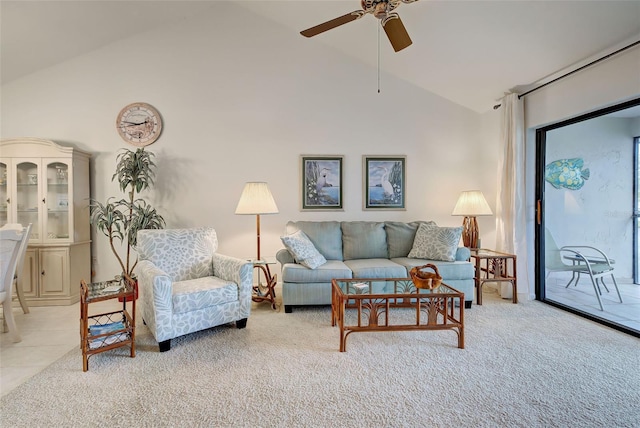 carpeted living room with ceiling fan and high vaulted ceiling