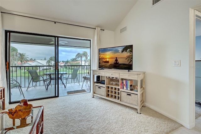 living room with lofted ceiling and carpet