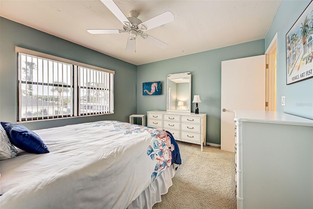 bedroom featuring light carpet and ceiling fan