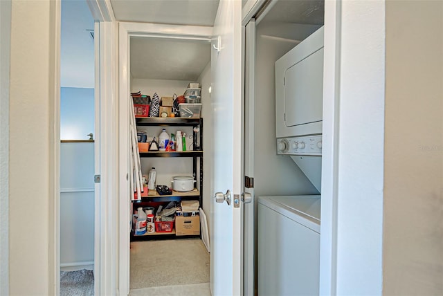 laundry area featuring light colored carpet and stacked washer and clothes dryer