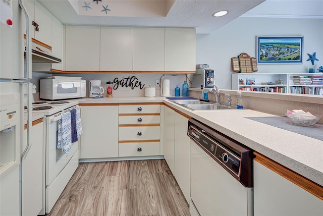 kitchen with white cabinetry, light hardwood / wood-style floors, sink, and white appliances