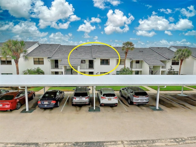 view of parking / parking lot featuring a carport