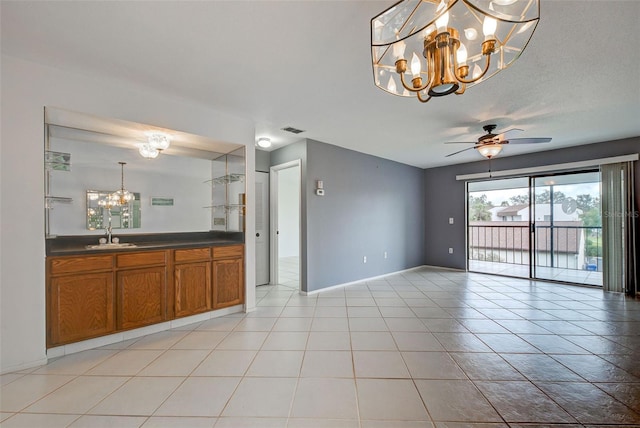 interior space with sink, ceiling fan with notable chandelier, and light tile patterned flooring