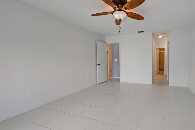 tiled empty room featuring ceiling fan