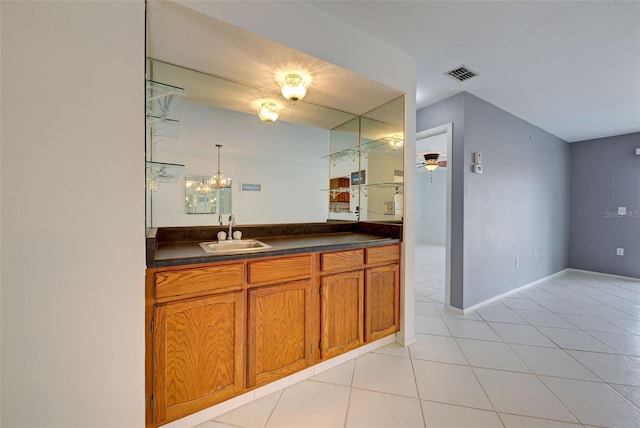 bar featuring pendant lighting, sink, light tile patterned floors, and ceiling fan