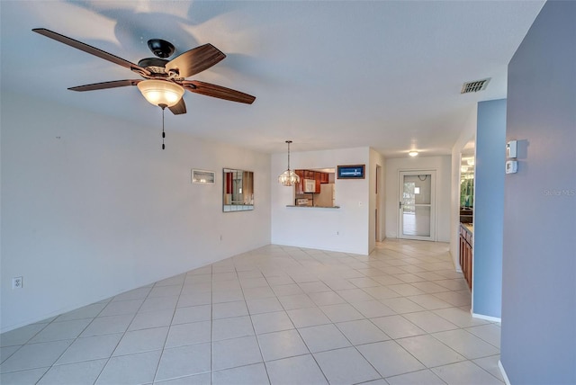 unfurnished living room featuring ceiling fan and light tile patterned floors