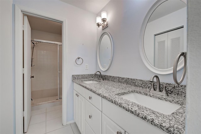 bathroom with vanity, an enclosed shower, and tile patterned floors