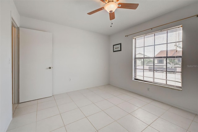 tiled empty room with ceiling fan