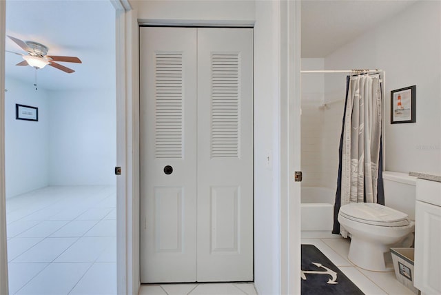 full bathroom featuring tile patterned flooring, toilet, ceiling fan, and shower / bath combo with shower curtain