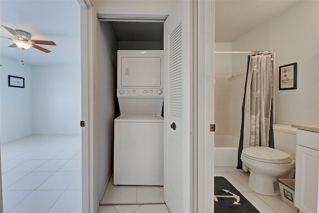 bathroom with shower / tub combo with curtain, stacked washer / drying machine, toilet, ceiling fan, and tile patterned flooring