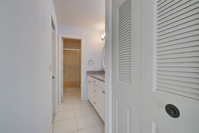 bathroom featuring vanity, tile patterned floors, and walk in shower