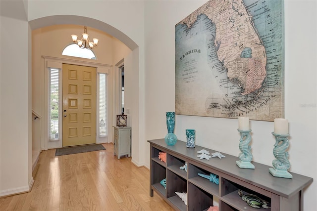 foyer featuring light hardwood / wood-style flooring and a notable chandelier