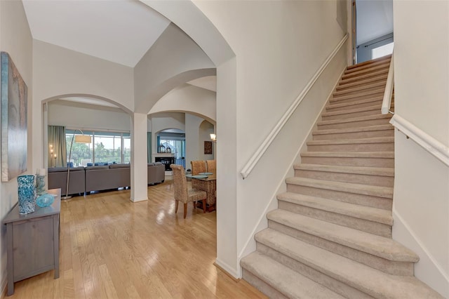 foyer with lofted ceiling and light hardwood / wood-style flooring