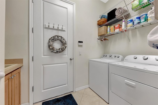 washroom featuring light tile patterned flooring and separate washer and dryer