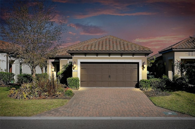 mediterranean / spanish-style house with a garage