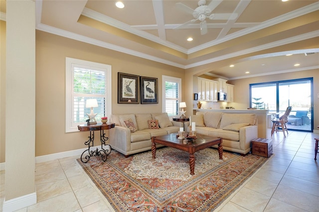 tiled living room featuring ornamental molding, coffered ceiling, and plenty of natural light