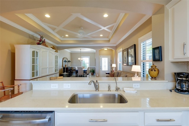 kitchen with stainless steel dishwasher, sink, coffered ceiling, and crown molding