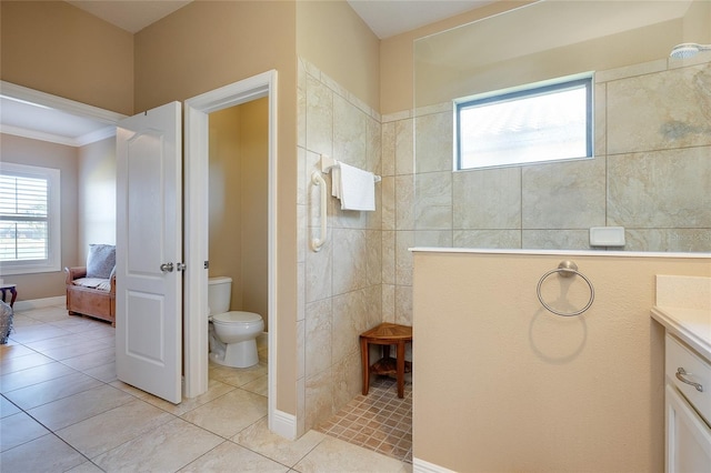 bathroom with vanity, tile patterned flooring, toilet, and walk in shower