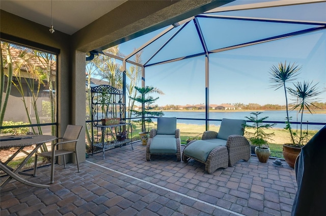 view of patio / terrace with a water view and glass enclosure