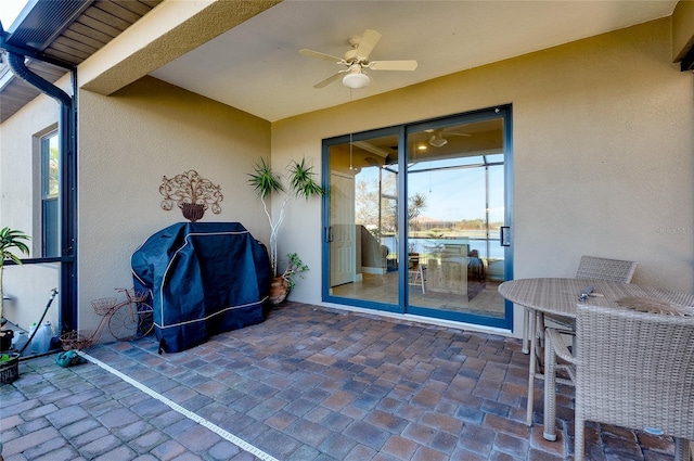 view of patio with ceiling fan and grilling area