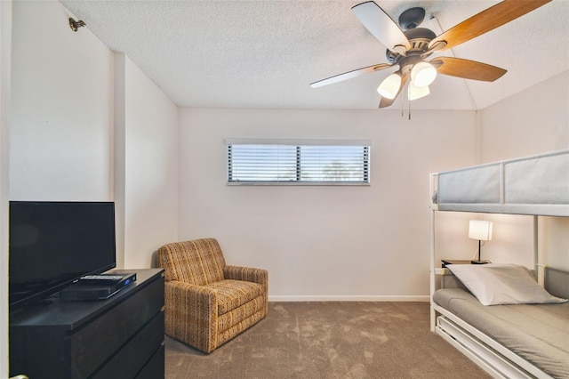 carpeted bedroom with ceiling fan and a textured ceiling