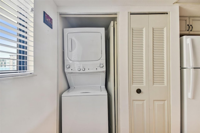 laundry area with stacked washer / dryer