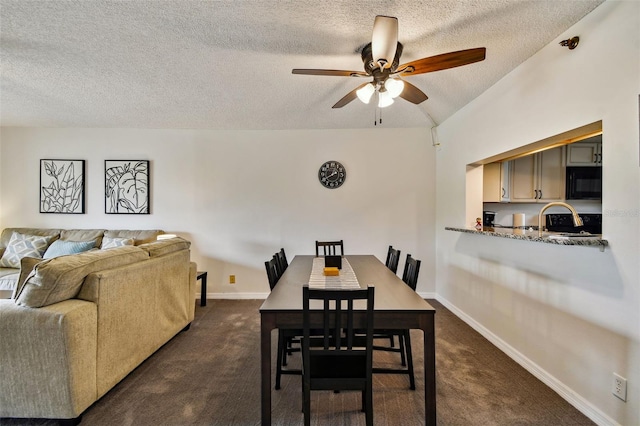 carpeted dining area with vaulted ceiling, ceiling fan, and a textured ceiling