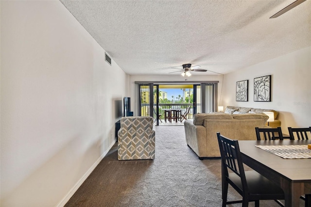 carpeted living room with ceiling fan and a textured ceiling