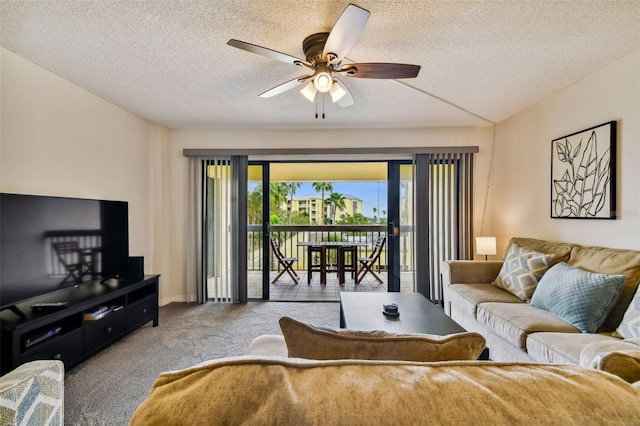 living room with light carpet, ceiling fan, and a textured ceiling