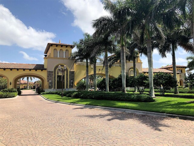 20190 Ragazza Cir Unit 202, Venice, FL 34293 - view of front of home with stucco siding, a tiled roof, and a front yard