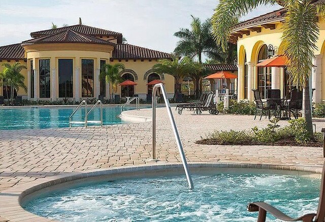 20190 Ragazza Cir Unit 202, Venice, FL 34293 - community pool featuring a community hot tub and a patio
