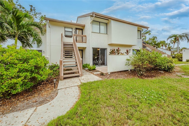 rear view of property with a lawn