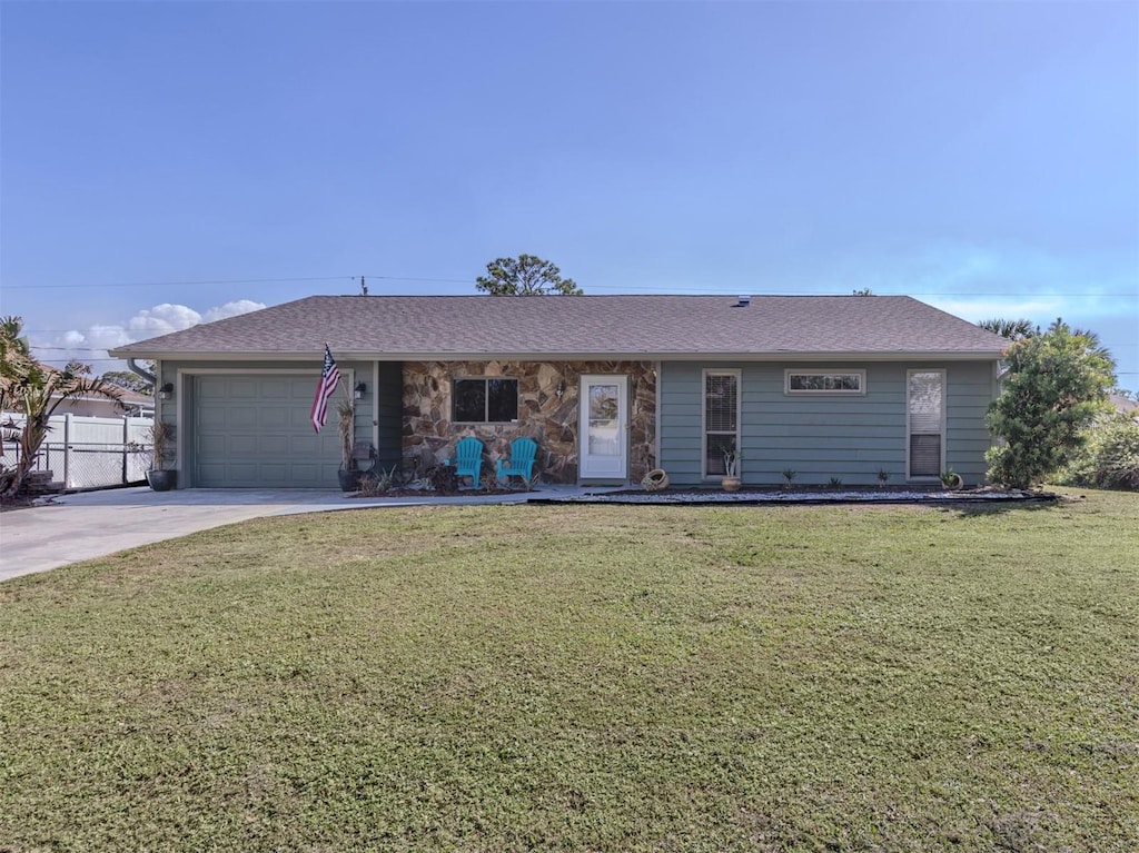 ranch-style home with a front yard and a garage