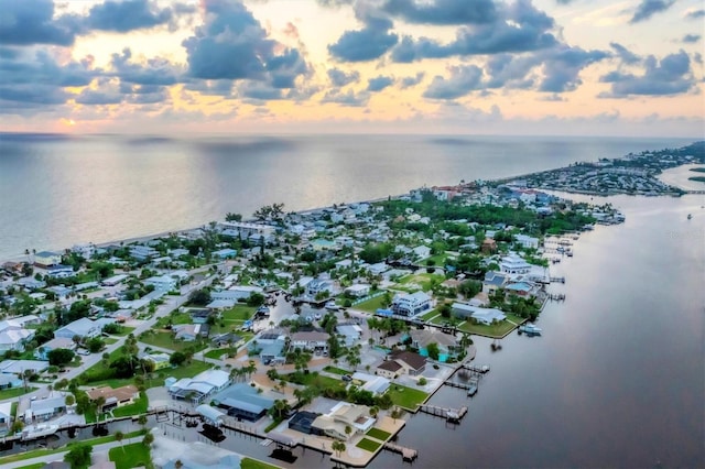 aerial view at dusk with a water view