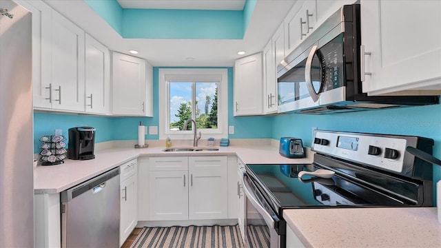 kitchen featuring sink, white cabinets, and appliances with stainless steel finishes