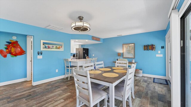 dining space with dark wood-type flooring