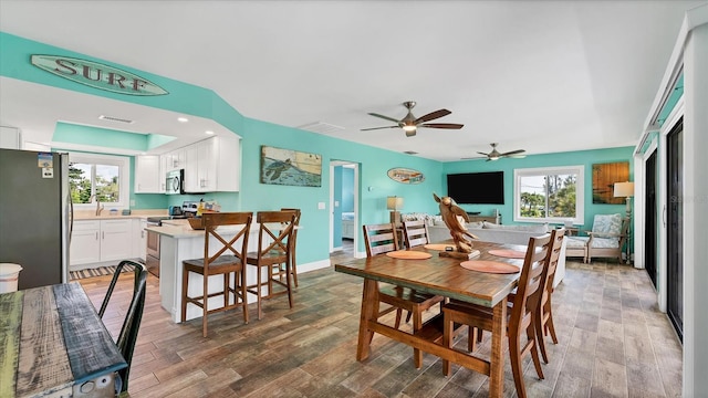 dining space with hardwood / wood-style flooring and ceiling fan