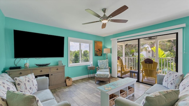 living room featuring light hardwood / wood-style floors and ceiling fan