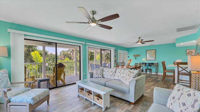 living room with hardwood / wood-style floors and ceiling fan