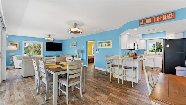 dining space with wood-type flooring