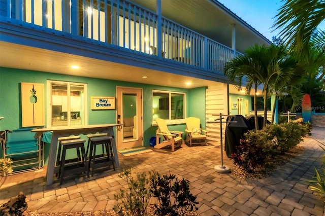 back of house with a balcony and a patio area