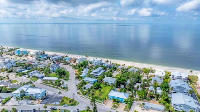 bird's eye view featuring a water view and a beach view