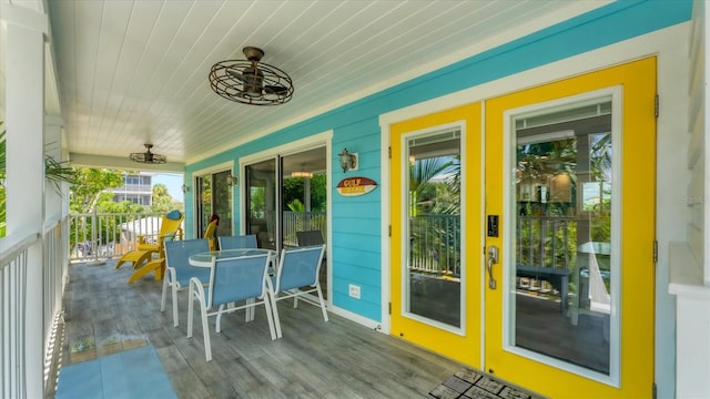 wooden terrace featuring ceiling fan and a porch