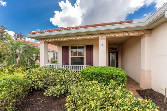 property entrance with covered porch