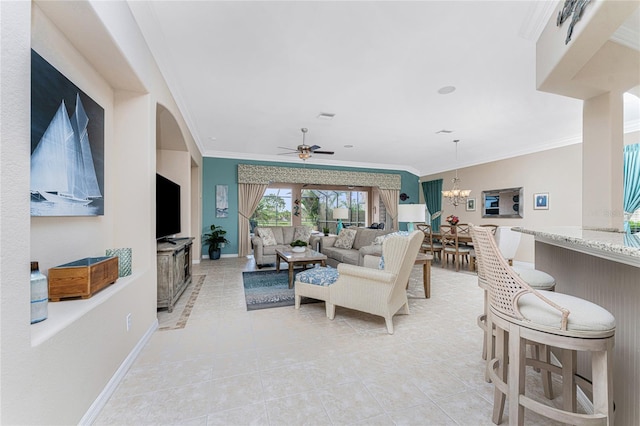 tiled living room featuring ceiling fan with notable chandelier and ornamental molding