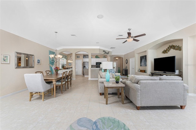 living room featuring light tile patterned floors, ceiling fan with notable chandelier, and crown molding